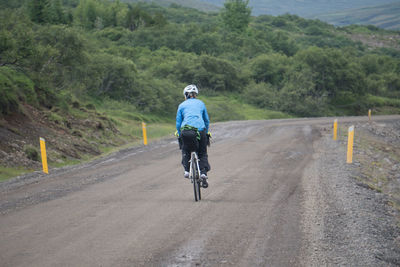 Man riding bicycle on road