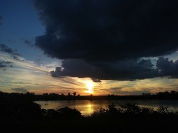 Scenic view of lake against sky during sunset