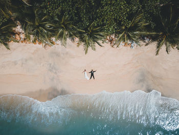 High angle view of people walking on beach