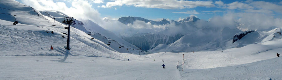 High angle view of ski resort against cloudy sky