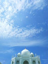 Low angle view of white mosque against sky