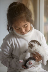 Cute girl holding kitten