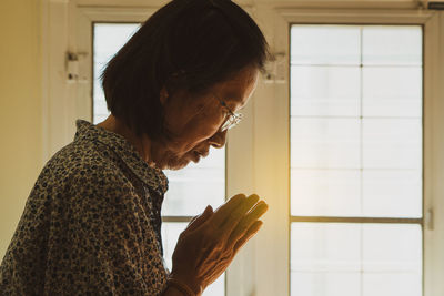 Side view of woman looking at camera