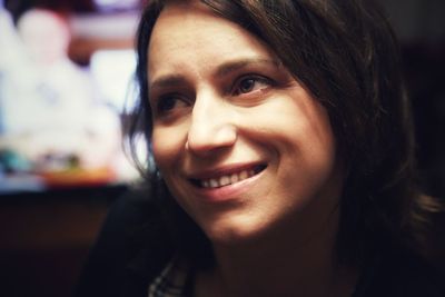 Close-up portrait of smiling young woman