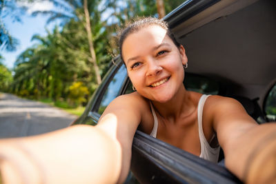 Portrait of young woman in car