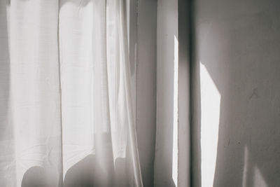 Close-up of curtain against window at home