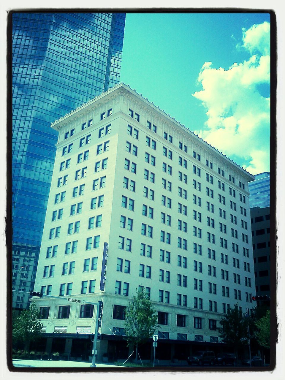 building exterior, architecture, built structure, city, low angle view, modern, office building, skyscraper, sky, building, tall - high, window, transfer print, blue, tower, glass - material, auto post production filter, day, reflection, residential building