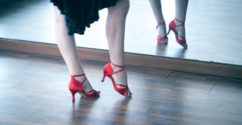 Low section of woman dancing on hardwood floor