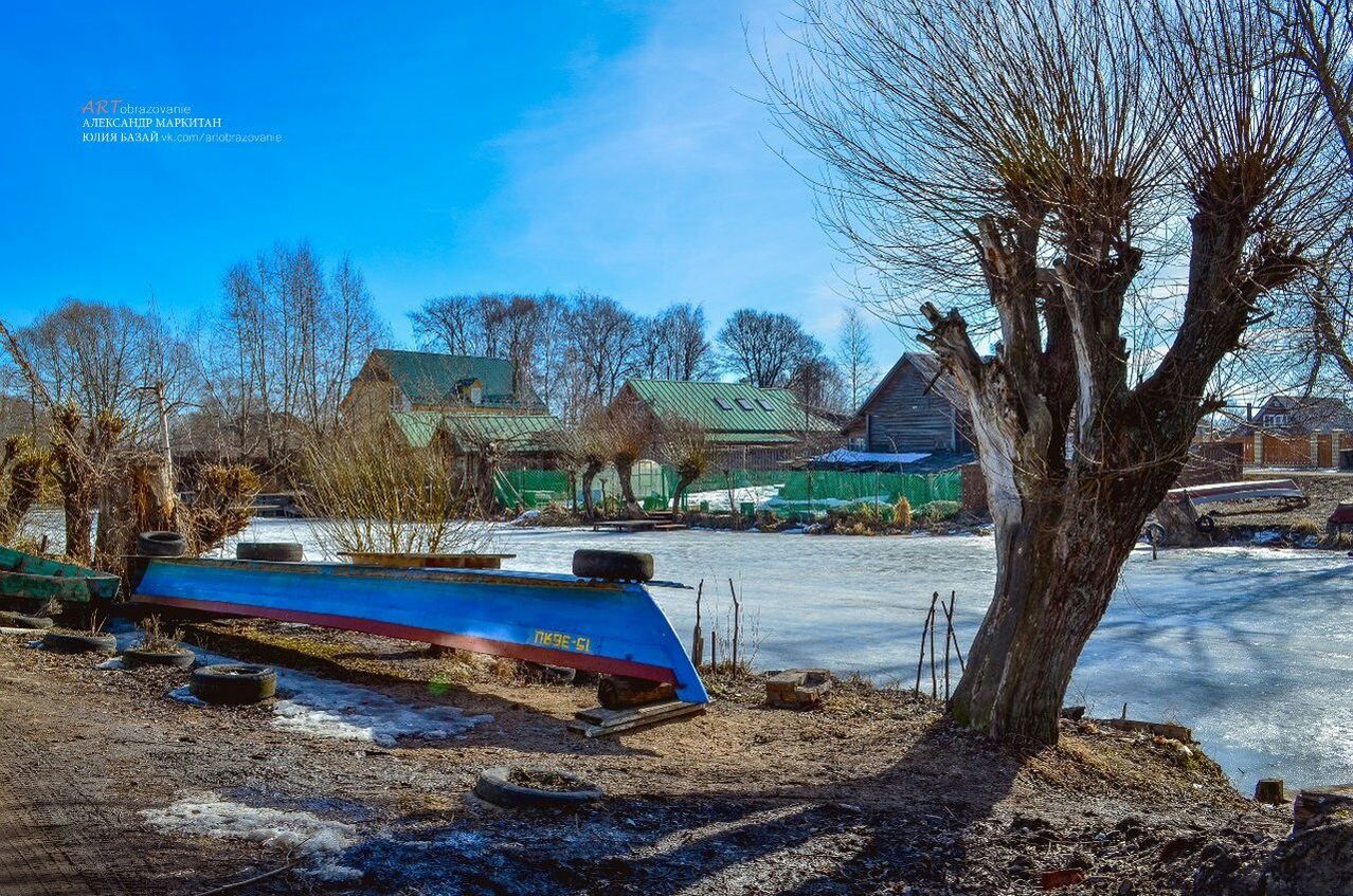 tree, water, blue, sky, bare tree, tranquil scene, tranquility, nature, built structure, scenics, beach, snow, beauty in nature, day, sunlight, architecture, building exterior, transportation, nautical vessel, shore