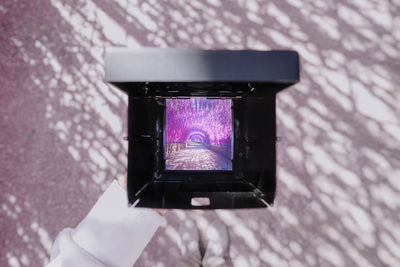 Cropped image of woman holding camera