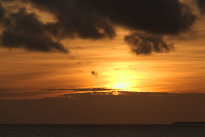 Scenic view of sea against orange sky