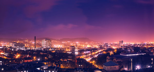 Scenic view of illuminated residential district during sunset