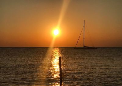 Scenic view of sea against orange sky