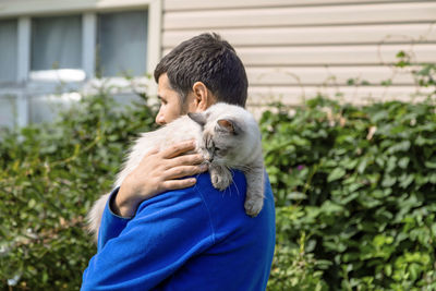 Siberian cat breed neva masquerade in the hands of the owner