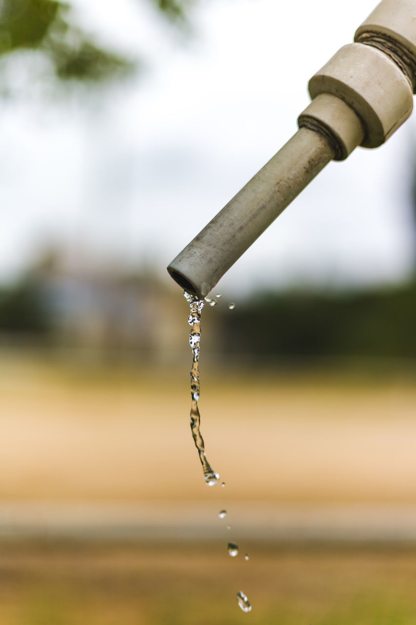 CLOSE-UP OF WATER FALLING FROM PIPE