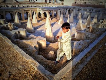 High angle view of boy walking at old ruin