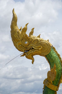 Low angle view of statue of angel against sky