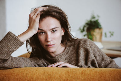 Close-up portrait of a young woman at home