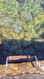 High angle view of rusty metal on rocks