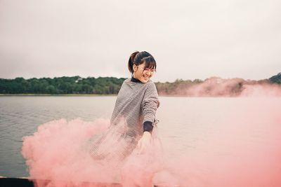 Portrait of young woman in lake