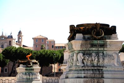 Close-up of statue against temple against clear sky