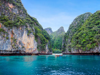 Scenic view of sea and mountains against sky