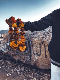 Close-up of rocks on rock against sky