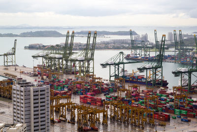 Boats moored at harbor against sky