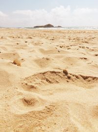 Close-up of sand on beach against sky