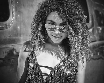 Portrait of smiling young woman with curly hair