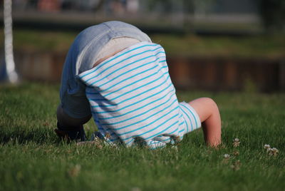 Playful baby boy on grassy field