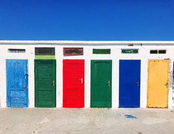 Closed door of beach against blue sky