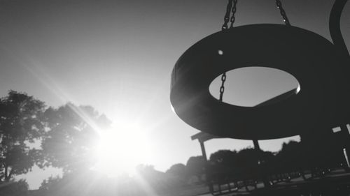 Low angle view of sun shining through trees