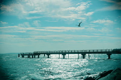 Bridge over sea against sky