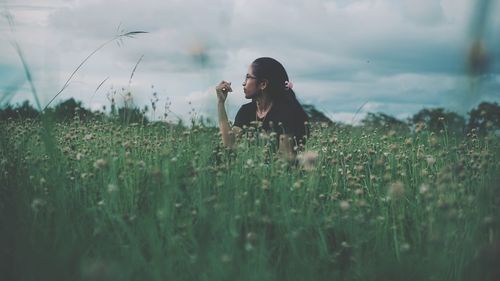 Woman standing on land against sky