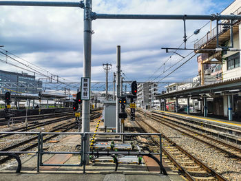 Train at railroad station against sky