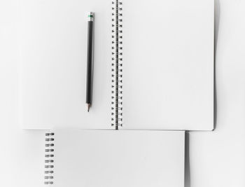 High angle view of pen on book against white background