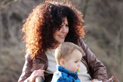 Mother with curly hair by baby boy