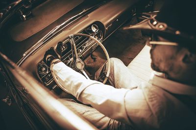 High angle view of man working in car