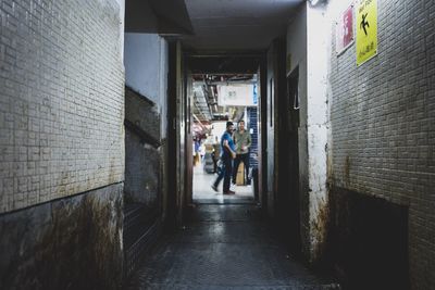 People walking in corridor of building