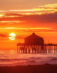 Pier on sea at sunset