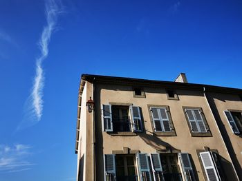 Low angle view of building against blue sky