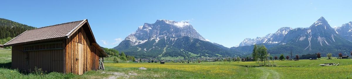 Panoramic shot of building and mountains against clear sky