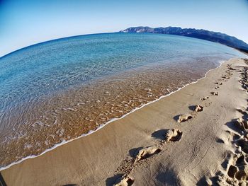 Scenic view of beach against clear sky