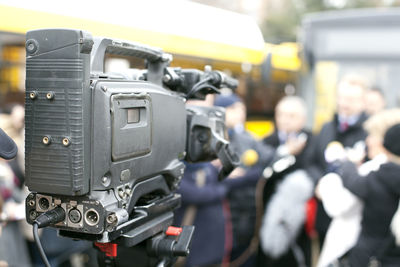 Close-up of camera against crowd