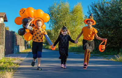 Full length of girl playing with balloons