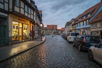 Street amidst buildings in city against sky