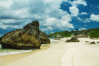 Rocks on beach against sky