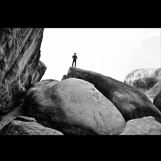 transfer print, clear sky, auto post production filter, copy space, rock - object, silhouette, full length, men, low angle view, day, rock, sitting, nature, outdoors, standing, rock formation, rear view, statue