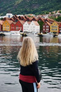 Young woman looking at bryggen in bergen